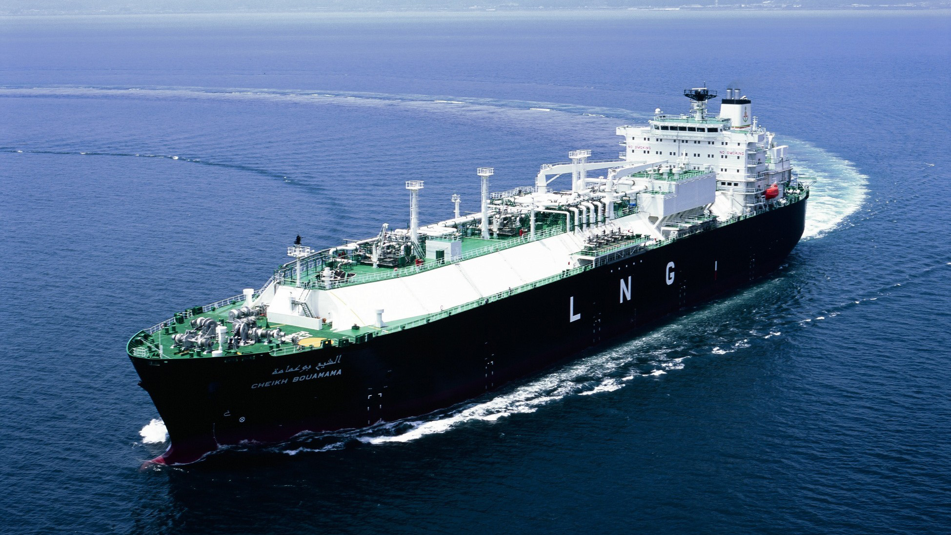 A large LNG tanker named ‘CHEIKH BOUMAMA’ with bold ‘LNG’ letters on its side sails smoothly through calm waters, highlighting its role in energy transport.