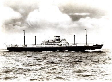 A black-and-white photograph of Hokokumaru with a long, streamlined structure sailing on calm waters.