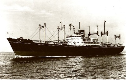 A black-and-white photograph of Osakamaru, the first postwar cargo ship built, sailing on a calm sea.